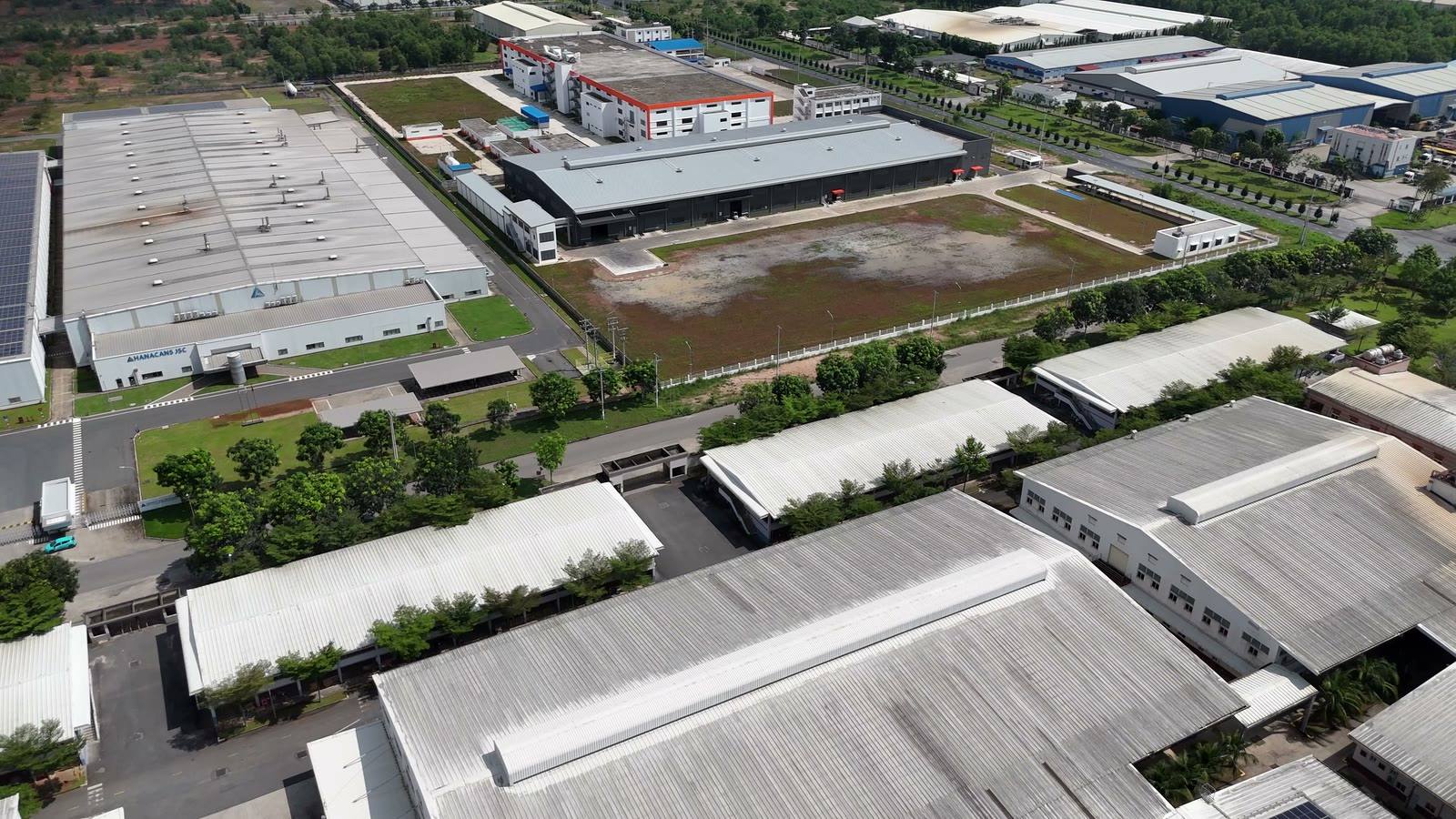 An aerial view of large factory roofs covered in solar panels