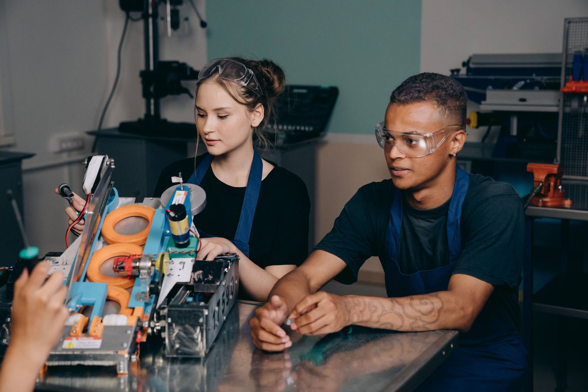 Two engineers building an automated test rig at a workbench